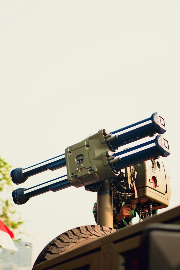 Close-up of military equipment mounted on a vehicle under clear sky