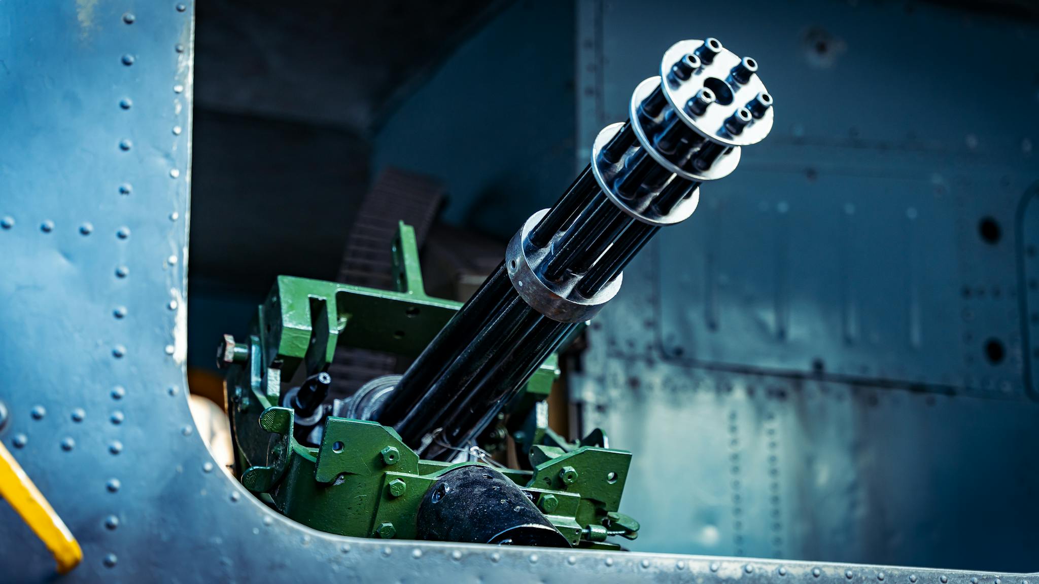 Detailed view of a gatling gun mounted on a military vehicle, showcasing mechanical design.